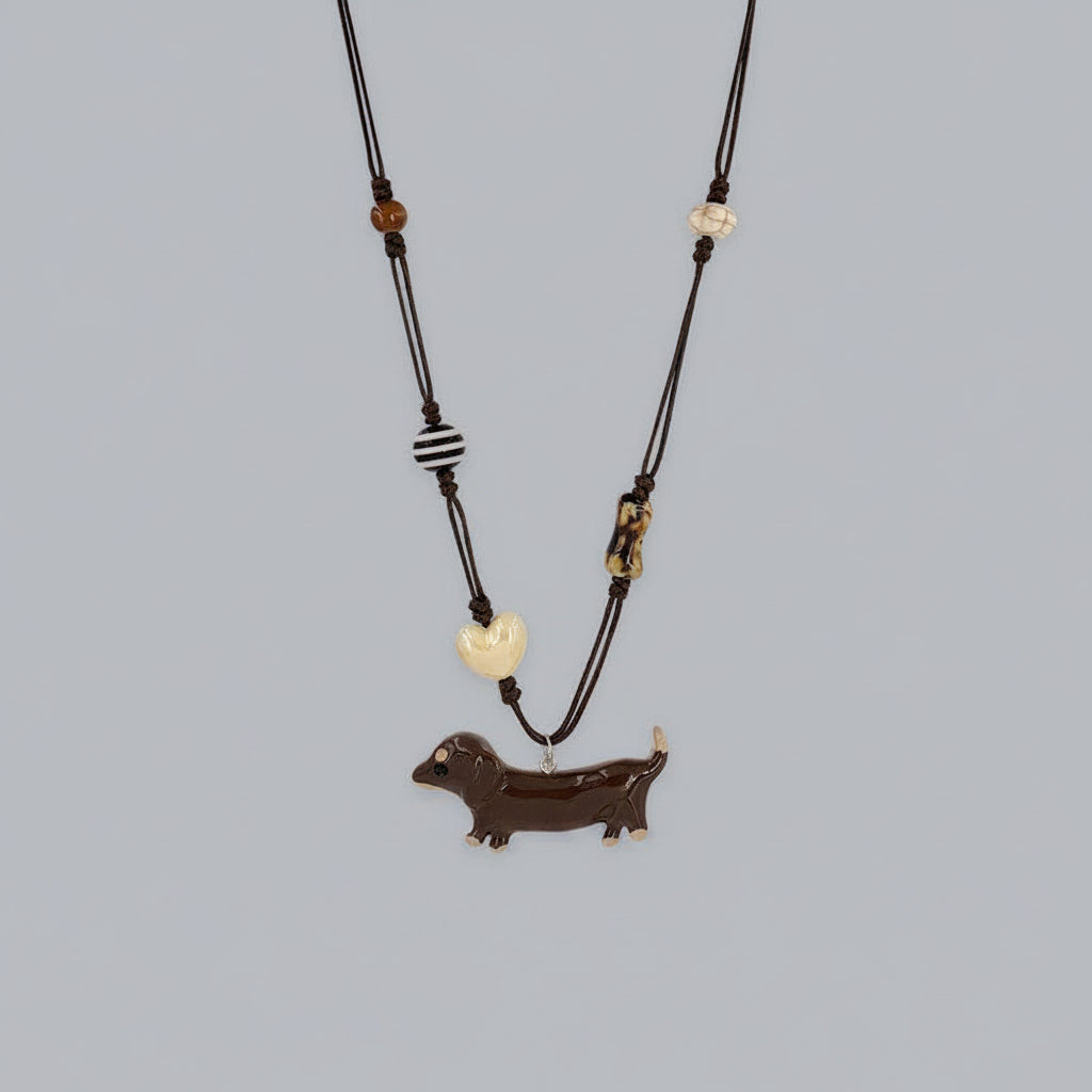 Necklace with a dachshund pendant on a gray background