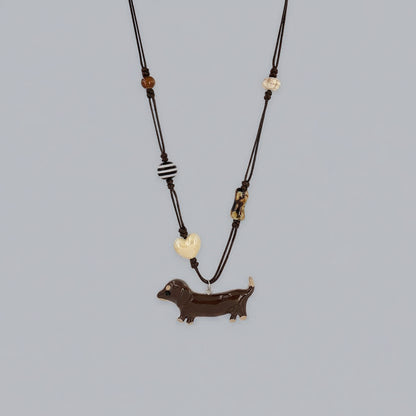 Necklace with a dachshund pendant on a gray background