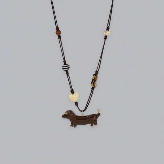 Necklace with a dachshund pendant on a gray background
